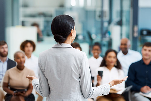 A woman presenting at a conference